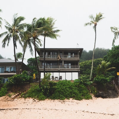 Beach house with palm trees in front